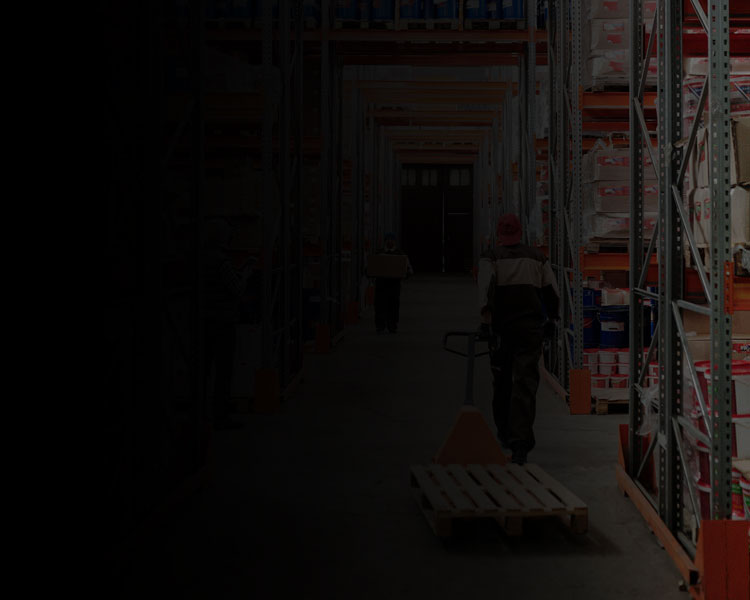 Man pulling pallet truck in warehouse