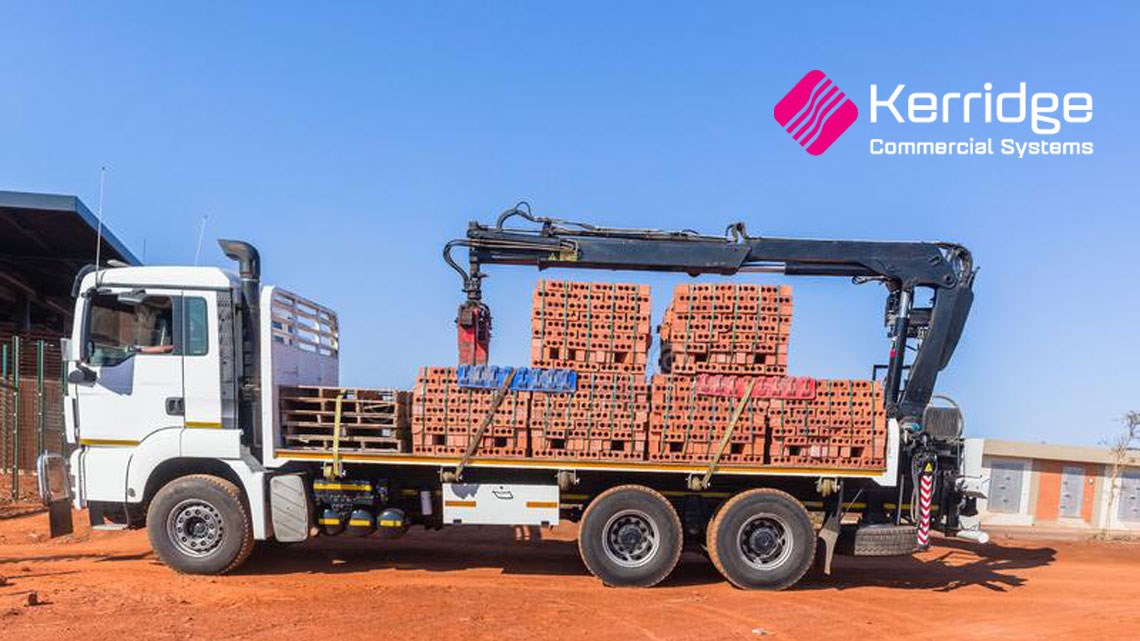 Crane truck loaded with piles of bricks