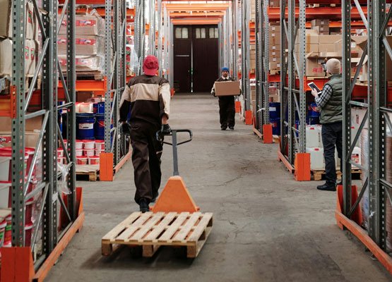 man with pallet truck in warehouse