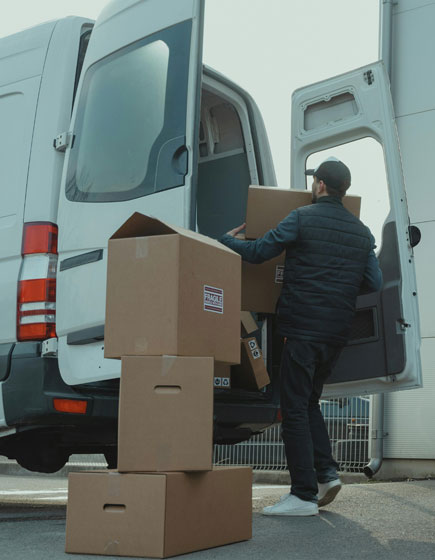 person loading van with boxes