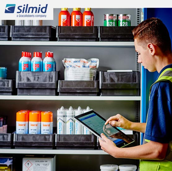 man with clipboard checking products for restocking