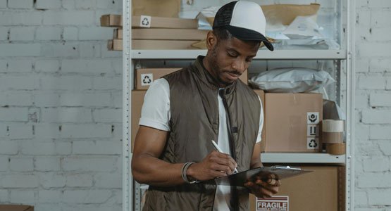 man with clipboard ordering packaging